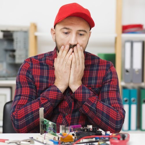 front-view-person-repairing-motherboard